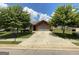 Charming one-story brick home with a two-car garage, lush lawn, and mature shade trees at 1687 Blue Heron Way, Hampton, GA 30228