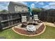 Cozy backyard area with a fire pit, surrounded by seating and manicured landscaping at 1687 Blue Heron Way, Hampton, GA 30228