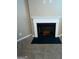 Close up on a fireplace with a white mantle and a black hearth at 1687 Blue Heron Way, Hampton, GA 30228