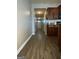View down long hallway with wood floors, and open doorway at 1687 Blue Heron Way, Hampton, GA 30228