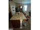Kitchen island with granite countertops and colorful modern barstools at 1687 Blue Heron Way, Hampton, GA 30228