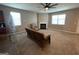 A spacious living room with a ceiling fan, fireplace, and lots of natural light at 1687 Blue Heron Way, Hampton, GA 30228