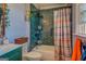 Stylish bathroom featuring sleek teal tiling in the shower and a modern vanity at 3579 Bill Gardner Pkwy, Locust Grove, GA 30248