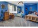 bedroom featuring two beds, carpeted floors, and bright blue walls at 3579 Bill Gardner Pkwy, Locust Grove, GA 30248