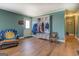 Convenient entryway features a coat rack with bench and wood floors at 3579 Bill Gardner Pkwy, Locust Grove, GA 30248