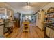 Open-concept kitchen featuring stainless steel appliances, a movable island, and wood flooring at 3579 Bill Gardner Pkwy, Locust Grove, GA 30248