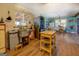 Rustic kitchen featuring blue walls, wood floors, stainless steel refrigerator, and open shelving at 3579 Bill Gardner Pkwy, Locust Grove, GA 30248