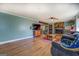 Bright living room features a stone fireplace, wood floors, and ample space for entertaining at 3579 Bill Gardner Pkwy, Locust Grove, GA 30248