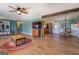 Large living room flows into the dining area, featuring wood floors and light-colored walls at 3579 Bill Gardner Pkwy, Locust Grove, GA 30248