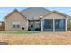 Backyard view showing screened porch and outdoor seating area on back patio at 108 Donovan Ave, Locust Grove, GA 30248