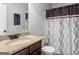 A well-lit bathroom with granite countertop, modern vanity, and decorative shower curtain at 108 Donovan Ave, Locust Grove, GA 30248