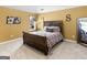 A cozy bedroom features soft carpet, a queen-sized bed, and an accent mirror at 108 Donovan Ave, Locust Grove, GA 30248