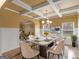 Elegant dining room featuring a coffered ceiling, modern chandelier, and seating for six at 108 Donovan Ave, Locust Grove, GA 30248