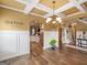 Elegant dining room featuring hardwood floors, decorative chandelier, and archway into the kitchen at 108 Donovan Ave, Locust Grove, GA 30248