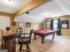 Spacious game room featuring a pool table, bar area, and carpeted floors at 108 Donovan Ave, Locust Grove, GA 30248