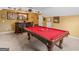 A rec room featuring a pool table with a rich wooden bar and plush carpet at 108 Donovan Ave, Locust Grove, GA 30248