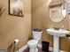 Cozy half bathroom featuring a pedestal sink and wood look flooring at 108 Donovan Ave, Locust Grove, GA 30248