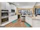 Bright kitchen featuring stainless steel appliances, white cabinetry, and easy access to the dining area at 108 Donovan Ave, Locust Grove, GA 30248