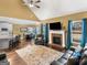 Spacious living room open to the kitchen, complete with brick fireplace, ceiling fan, and hardwood floors at 108 Donovan Ave, Locust Grove, GA 30248