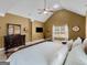 Vaulted ceiling main bedroom featuring a dark wood dresser and a ceiling fan at 108 Donovan Ave, Locust Grove, GA 30248