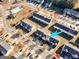 Aerial view of neighborhood showing the home with a nearby community pool surrounded by colorful trees at 1235 Labonte Pkwy, Mcdonough, GA 30253