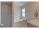 Bright bathroom with a bathtub, shower with curtain, and neutral wall and flooring at 1235 Labonte Pkwy, Mcdonough, GA 30253