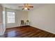 Bright bedroom featuring wood floors, a ceiling fan, and a cozy sitting area by the window at 1235 Labonte Pkwy, Mcdonough, GA 30253