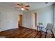 Bedroom with wood flooring, a ceiling fan, double closets, and view into the attached bathroom at 1235 Labonte Pkwy, Mcdonough, GA 30253