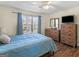 Bedroom featuring hardwood floors, a ceiling fan, and a large window at 1235 Labonte Pkwy, Mcdonough, GA 30253