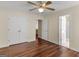 Bedroom with laminated floors, ceiling fan, double doors closet, and view to the bathroom at 1235 Labonte Pkwy, Mcdonough, GA 30253