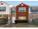 Charming townhouse featuring a red brick facade and well-maintained front yard landscaping at 1235 Labonte Pkwy, Mcdonough, GA 30253