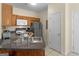 Bright kitchen with granite countertops, stainless steel refrigerator, and white appliances at 1235 Labonte Pkwy, Mcdonough, GA 30253