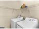 Well-organized laundry room with shelving above the washer and dryer for convenient storage at 1235 Labonte Pkwy, Mcdonough, GA 30253