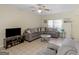 Comfortable living room features tile flooring, a gray sectional, and natural lighting at 1235 Labonte Pkwy, Mcdonough, GA 30253