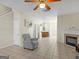 Bright living space with a cozy reading chair, fireplace, and tile floors at 1235 Labonte Pkwy, Mcdonough, GA 30253