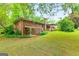 Brick home with an inviting back patio overlooking a spacious yard, perfect for outdoor living and entertaining at 437 Forrest Ave, Fayetteville, GA 30214