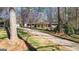 Ranch-style home with a long driveway, mature trees and front lawn at 437 Forrest Ave, Fayetteville, GA 30214