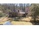 A sprawling brick home features a large fenced backyard with a covered porch and mature trees at 437 Forrest Avenue Ave, Fayetteville, GA 30214