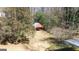 A fenced backyard features a covered structure or shed, surrounded by trees, providing both privacy and function at 437 Forrest Avenue Ave, Fayetteville, GA 30214
