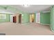 Large basement space with green walls, carpeted flooring and storage shelving at 437 Forrest Avenue Ave, Fayetteville, GA 30214