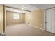 A simple room featuring carpet floors, neutral walls, and a window offering natural light at 437 Forrest Avenue Ave, Fayetteville, GA 30214
