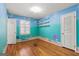 A unique bedroom with a sea themed hand-painted wall and hardwood floors at 437 Forrest Avenue Ave, Fayetteville, GA 30214