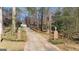 Long driveway leading to a secluded home surrounded by mature trees and landscaping at 437 Forrest Avenue Ave, Fayetteville, GA 30214