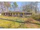 Charming single-story home featuring a blue front door, brick accents, and a well-maintained lawn at 437 Forrest Avenue Ave, Fayetteville, GA 30214