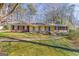 Charming single-story home featuring a blue front door, brick accents, and a well-maintained lawn at 437 Forrest Avenue Ave, Fayetteville, GA 30214