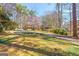A home featuring a lush lawn and mature trees, providing a serene and private setting at 437 Forrest Avenue Ave, Fayetteville, GA 30214