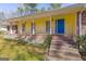 Inviting front porch with brick stairs and yellow siding, perfect for enjoying outdoor living at 437 Forrest Avenue Ave, Fayetteville, GA 30214