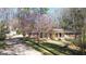 Charming home featuring a well-manicured lawn, blossoming tree, and a welcoming blue front door at 437 Forrest Avenue Ave, Fayetteville, GA 30214