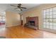 Open living room with hardwood floors, brick fireplace, and a ceiling fan at 437 Forrest Avenue Ave, Fayetteville, GA 30214