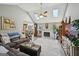 Open-concept living room featuring a vaulted ceiling, skylights, fireplace and updated floors at 306 Preston Chase Dr, Peachtree City, GA 30269